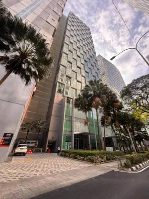 a tall building with palm trees in front of it at Soho Suites KLCC by Leala in Kuala Lumpur