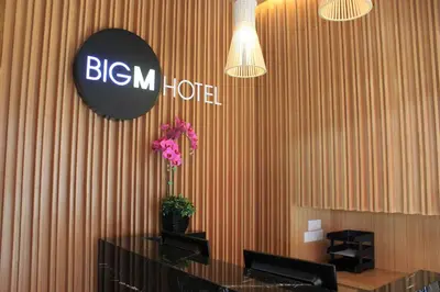 a lobby with a desk and a sign on a wall at BIG M Hotel in Kuala Lumpur