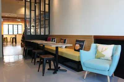 a restaurant with a bar with a blue chair at BIG M Hotel in Kuala Lumpur