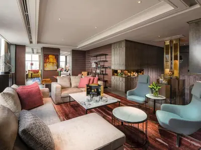 a living room with couches and chairs and a fireplace at Sofitel Kuala Lumpur Damansara in Kuala Lumpur