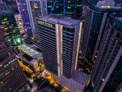 a tall building in a city at night at Sofitel Kuala Lumpur Damansara in Kuala Lumpur