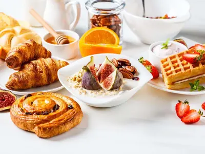 a table topped with plates of breakfast foods at Sofitel Kuala Lumpur Damansara in Kuala Lumpur