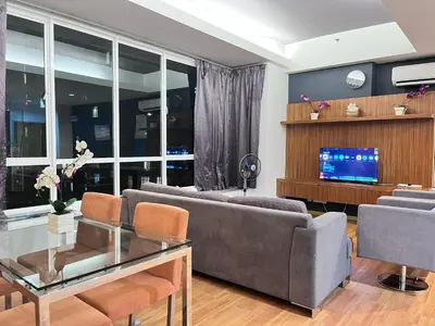 a living room with a couch and a tv at Parkview Suite KLCC, Bernice in Kuala Lumpur