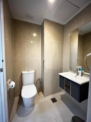 a bathroom with a toilet and a sink at Parkview Suite KLCC, Bernice in Kuala Lumpur