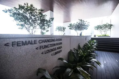 a lobby with trees and plants in a building at KL Sentral Bangsar Suites EST BY PSM LUXURY SUITES in Kuala Lumpur