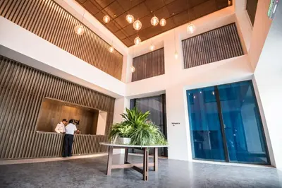 a couple taking a picture in the lobby of a building at KL Sentral Bangsar Suites EST BY PSM LUXURY SUITES in Kuala Lumpur