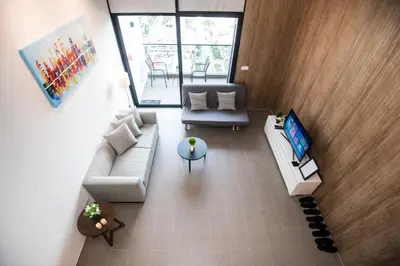 an overhead view of a living room with a couch and a tv at KL Sentral Bangsar Suites (EST) by Luxury Suites Asia in Kuala Lumpur