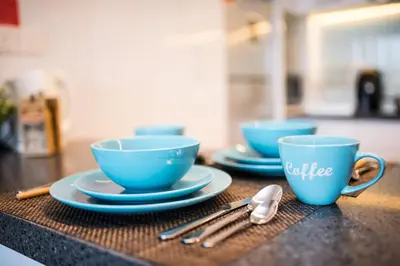 three blue cups and saucers sitting on a counter at KL Sentral Bangsar Suites (EST) by Luxury Suites Asia in Kuala Lumpur