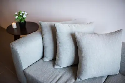 a set of four pillows on a couch with a table at KL Sentral Bangsar Suites (EST) by Luxury Suites Asia in Kuala Lumpur