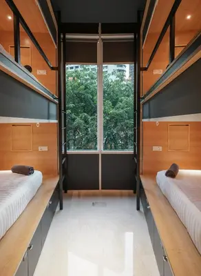 two bunk beds in a room with a window at The Bed KLCC in Kuala Lumpur