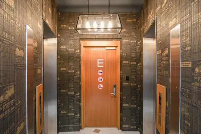 a hallway with a wooden door in a building at The Bed KLCC in Kuala Lumpur