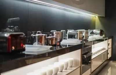 a kitchen with a counter with white dishes on it at The Bed KLCC in Kuala Lumpur