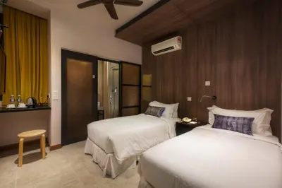 a hotel room with two beds and a window at Hotel Twenty 8B in Kuala Lumpur