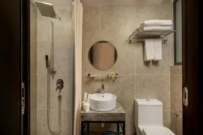 a bathroom with a sink and a toilet and a mirror at Hotel Twenty 8B in Kuala Lumpur