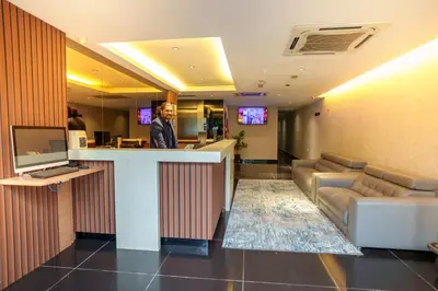 a man standing at a bar in a hotel lobby at Alaxis Hotel in Kuala Lumpur