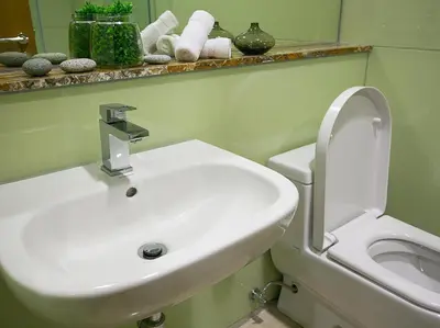 a bathroom with a white sink and a toilet at Soho Suites KLCC by 21 Century travel in Kuala Lumpur
