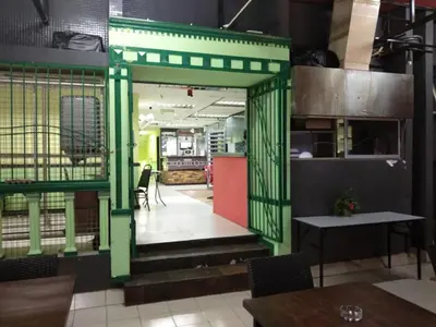 an open door to a restaurant with a table and chairs at Petaling Street Hotel Chinatown in Kuala Lumpur