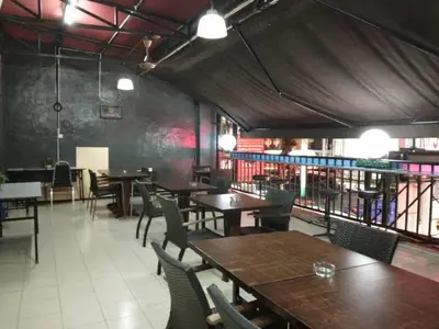a restaurant with wooden tables and chairs at Petaling Street Hotel Chinatown in Kuala Lumpur