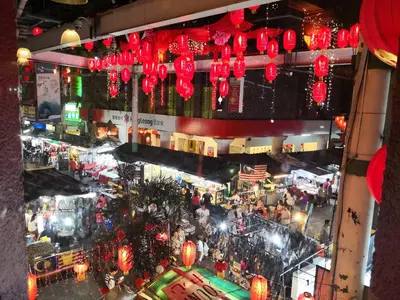 an overhead view of a city market with red lanterns at Petaling Street Hotel Chinatown in Kuala Lumpur