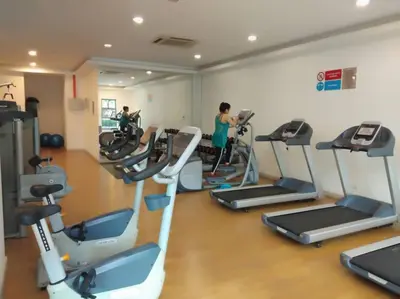 a gym with several tread machines in a room at Apartment by WGS Homestay Bukit Bintang in Kuala Lumpur