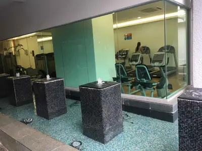 a gym with chairs and a woman in the mirror at Apartment by WGS Homestay Bukit Bintang in Kuala Lumpur