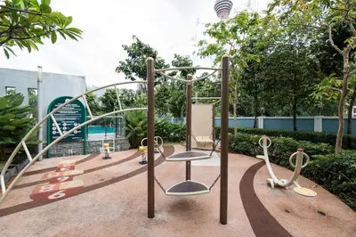 a playground in a park with two swings at Apartment by WGS Homestay Bukit Bintang in Kuala Lumpur