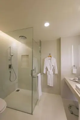 a bathroom with a shower and a glass shower stall at DoubleTree By Hilton Kuala Lumpur in Kuala Lumpur
