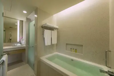 a bathroom with a large tub and a sink at DoubleTree By Hilton Kuala Lumpur in Kuala Lumpur