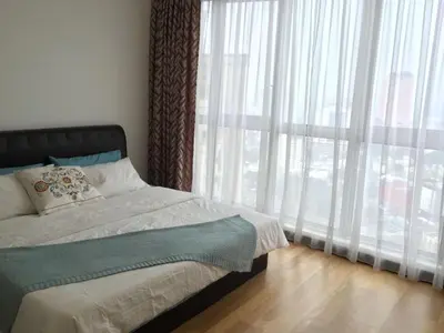 a bedroom with a bed and a large window at Suites & Residences @ Regalia by PLC in Kuala Lumpur