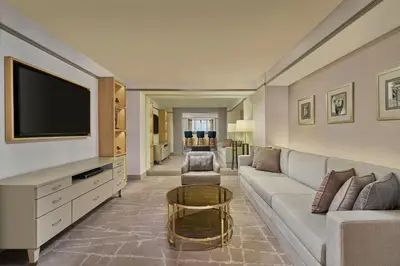 a living room with a couch and a tv at Sheraton Imperial Kuala Lumpur Hotel in Kuala Lumpur