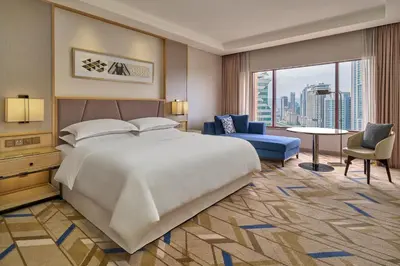 a bedroom with a large bed and a large window at Sheraton Imperial Kuala Lumpur Hotel in Kuala Lumpur