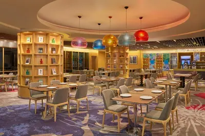 a dining room with tables and chairs and books at The Westin Kuala Lumpur in Kuala Lumpur