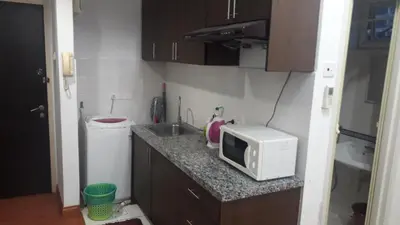 a small kitchen with a microwave and a sink at Maytower Service Suite - Masjid India in Kuala Lumpur
