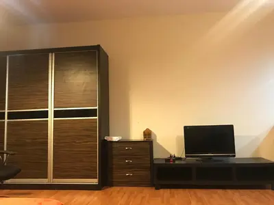 a living room with a television and a dresser at Maytower Service Suite - Masjid India in Kuala Lumpur