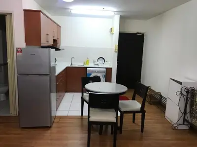 a kitchen with a table and chairs and a refrigerator at Maytower Service Suite - Masjid India in Kuala Lumpur