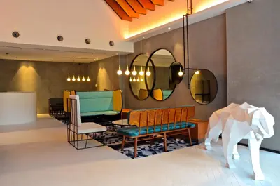 a living room with a chair and a table at MOV Hotel Kuala Lumpur in Kuala Lumpur