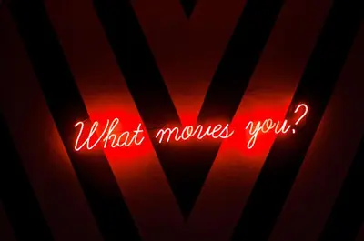 a red neon sign that says what moves you at MOV Hotel Kuala Lumpur in Kuala Lumpur