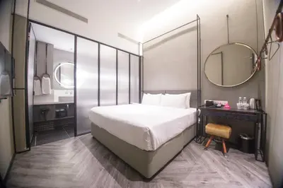 a bedroom with a large bed and a mirror at MOV Hotel Kuala Lumpur in Kuala Lumpur