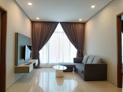 a living room with a couch and a television at Soho Suites KLCC by LX Suites 2 in Kuala Lumpur