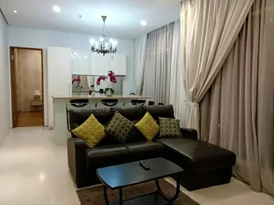 a living room with a leather couch and a table at Soho Suites KLCC by LX Suites 2 in Kuala Lumpur