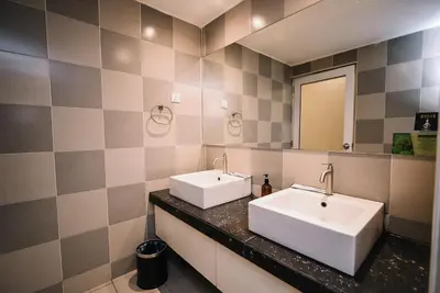 a bathroom with two sinks and a mirror at Kingston Hotel 1 - Bukit Bintang in Kuala Lumpur