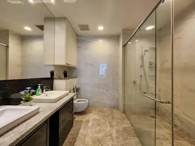 a bathroom with two sinks and a glass shower at KL Platinum KLCC By Hive KL in Kuala Lumpur