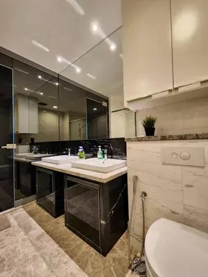 a large bathroom with two sinks and a toilet at KL Platinum KLCC By Hive KL in Kuala Lumpur