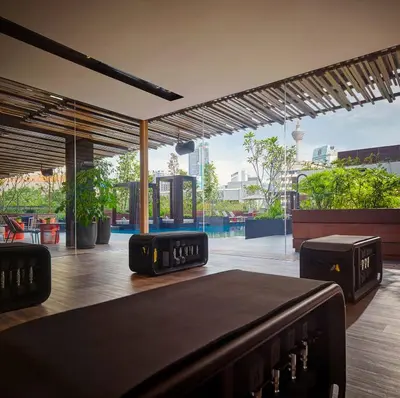 a room with a patio with a view of a pool at PARKROYAL COLLECTION Kuala Lumpur in Kuala Lumpur