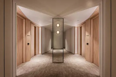 a hallway with a mirror in the middle of a room at PARKROYAL COLLECTION Kuala Lumpur in Kuala Lumpur