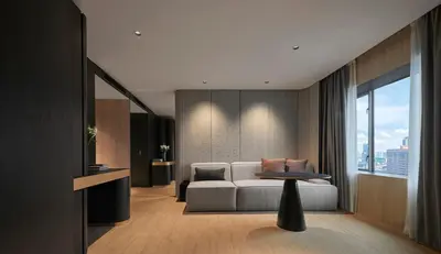 a living room with a couch and a table at PARKROYAL COLLECTION Kuala Lumpur in Kuala Lumpur