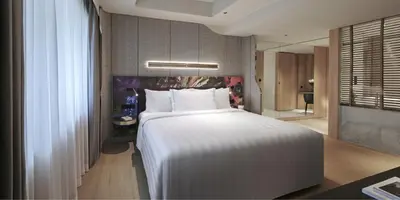 a bedroom with a large white bed in a room at PARKROYAL COLLECTION Kuala Lumpur in Kuala Lumpur