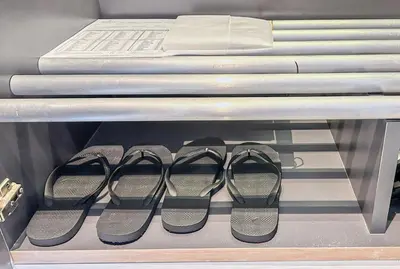 a row of pairs of shoes on a shelf at The Federal Kuala Lumpur in Kuala Lumpur