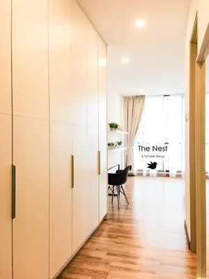 a hallway with white cabinets and a chair in a room at KL Gateway Residency in Kuala Lumpur