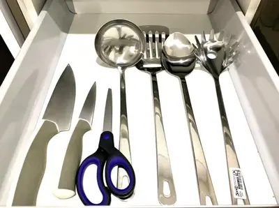 a drawer with some utensils in a box at KL Gateway Residency in Kuala Lumpur